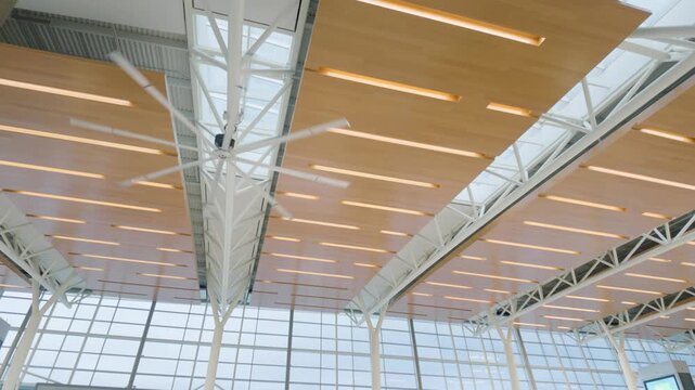 Calgary, Alberta, Canada - October 13, 2026: Modern architectural wood panel ceiling and large ceiling fan at Calgary International Airport