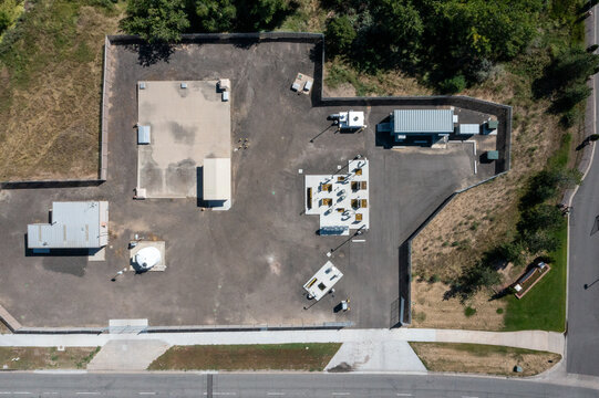Aerial view of a water treatment facility featuring industrial equipment, storage tanks, and concrete pads enclosed within a fenced perimeter in Colorado, United States.