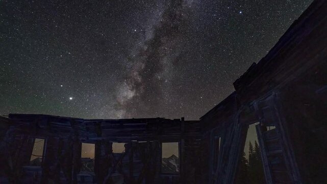An old mining building as the milky way passes through in Colorado