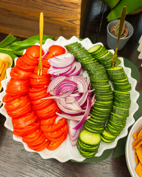 Fresh Sliced Tomatoes Cucumbers and Red Onion on Buffet Platter