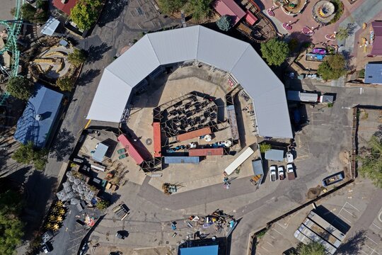 Aerial view of Elitch Gardens with its central semi-circular building, maze structure, and shipping containers at the amusement park in Denver, Colorado, United States.