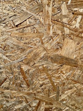 Oriented strand board OSB wood texture background with detailed wooden chips