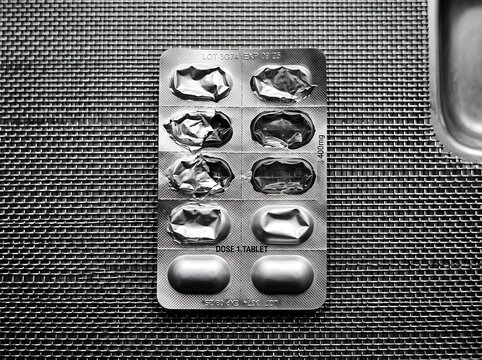A partially used blister pack of 400mg tablets on a textured surface