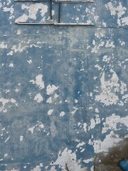 Close-up of weathered blue painted wooden boards on an abandoned boat near the yacht club in San Fernando, Cadiz, Spain, showing peeling paint and a distressed marine texture. © maru
