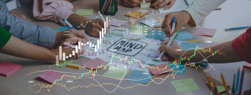 A dynamic business scene showing hands at work on a mind map surrounded by charts and data. This image captures collaboration and creativity in strategy planning. Scalp