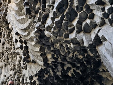 Natural hexagonal basalt columns forming a rock texture