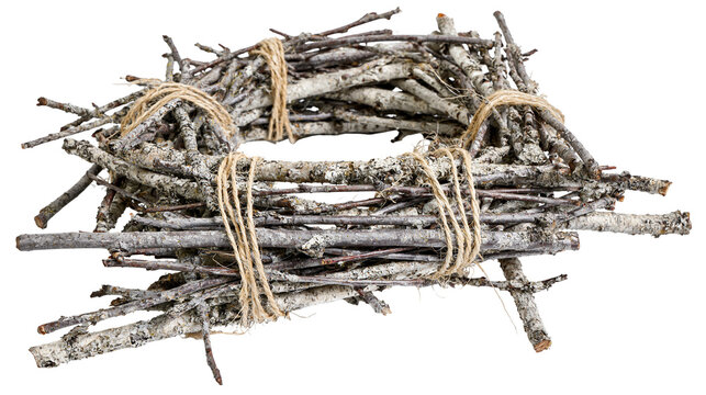 Isolated bundle of dry tree branches tied with natural twine, weathered wood texture.