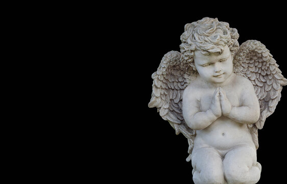 White marble cherub angel statue on black background
