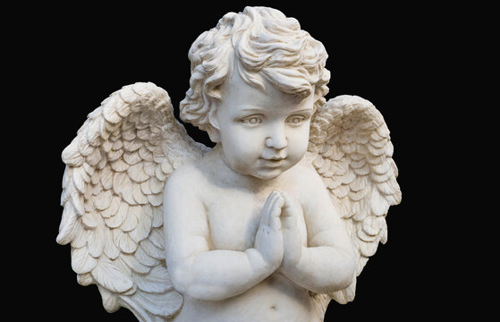 White marble cherub angel statue on black background