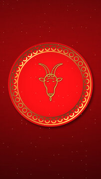 Vertical embossed gold goat head with curved horns on a round red medallion, deep crimson