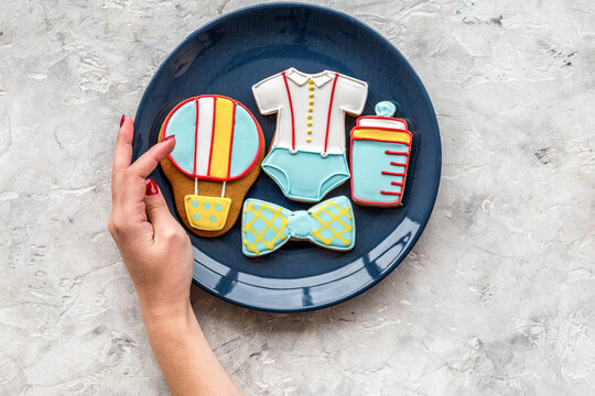 Child birthday celebration with gingerbread cookies on plate on stone background top view space for text