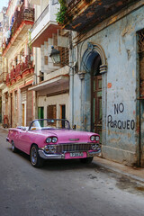 Pink classic convertible on a narrow street in Old Havana, Cuba, North America