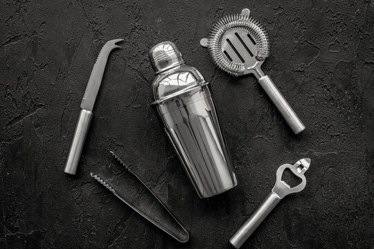 Instruments bartender. Shaker, strainer on black background top view