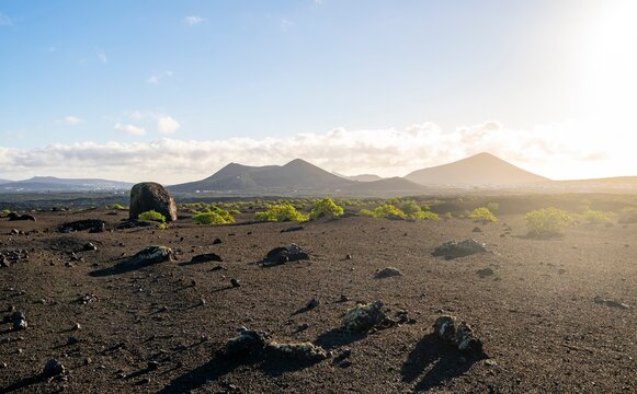 Large round volcanic stone Bomba volc&aacute;nica Gude, volcanic landscape with lava fields, Parque Natural de Los Volcanes, Lanzarote, Canary Islands, Spain
