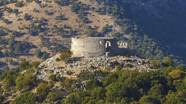 A medieval castle ruin on a hill surrounded by a wooded mountainous area, Askifou Plateau, Lefka Ori, White Mountains, mountain massif, west, Crete, Greece