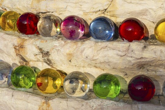 The colored glass balls are part of the large-scale mosaic decoration, which consists of millions of glass and ceramic elements, they symbolize purity and clarity of mind and support the meditative and spiritual ambiance of the temple complex, Buddhist temple complex Wat Phra That Sorn Kaew, Khao Kho Mountains, Phetchabun province, Isan, Thailand