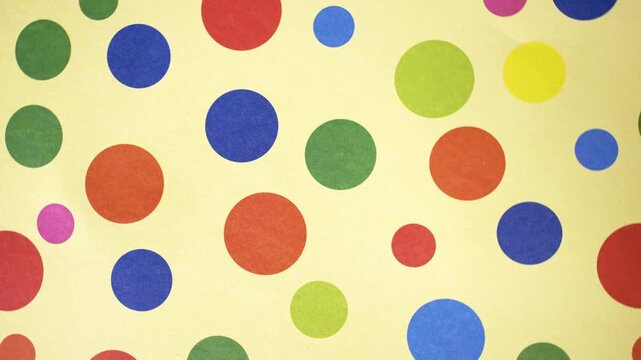 Rotating Multi Color Polka Dots on Yellow Background Motion Video
