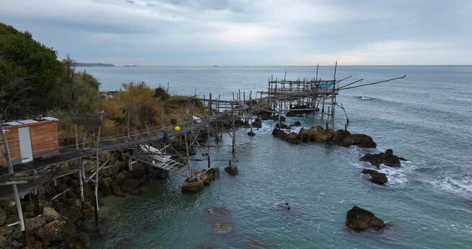 Aerial view of Trabocco Lupone, a traditional wooden fishing structure on stilts over the Adriatic Sea, with a wooden walkway in Marina di San Vito, Provincia di Chieti, Italy.