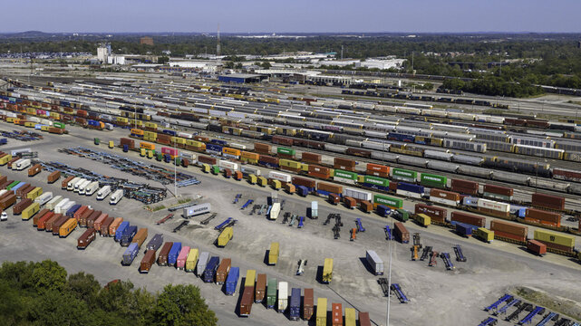 Aerial view of CSX's Radnor Yard and Nashville Intermodal train terminal with freight trains, colorful shipping containers, and rail tracks. Nashville, TN, United States.
