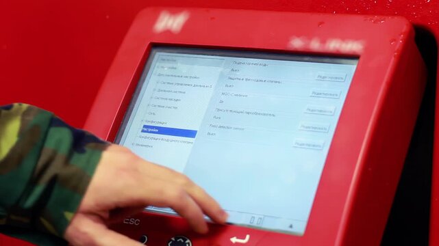 Operator hand touching screen control panel. Closeup milking robot settings.