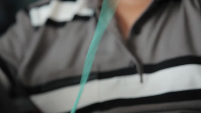 Hands knotting green fishing net in close up