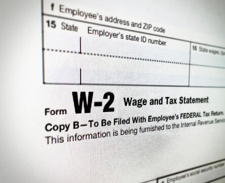 Close up of form W-2 wage and tax statement for employee federal tax filing copy, sample text