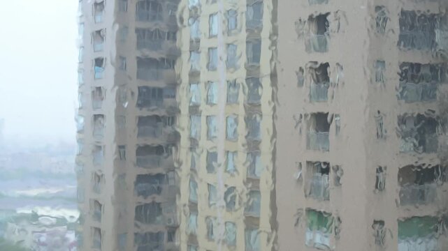 Residential high rise buildings viewed through rain covered window glass video with sound