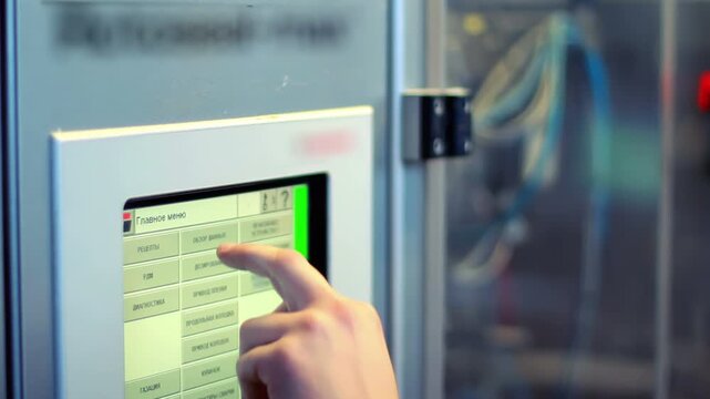 Closeup hand pressing touchscreen control panel. Worker entering password code.