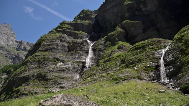 Two waterfalls descending alpine cliffs near Chamonix