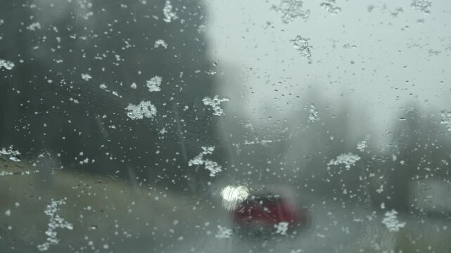 Bad weather, road traffic through a windscreen in heavy snowfall, Austria