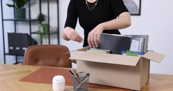 Woman packing her things after being fired, closeup. Concept of unemployment