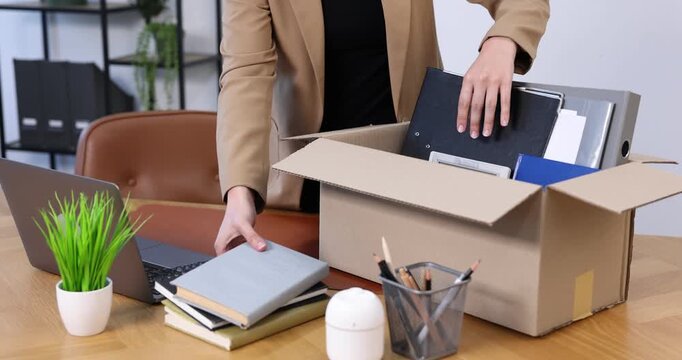 Woman packing her things after being fired, closeup. Concept of unemployment