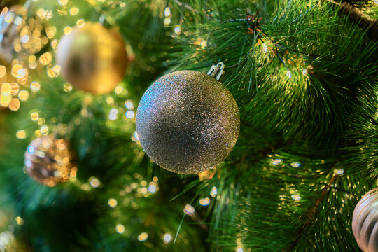 Silver Glitter Christmas Bauble on a Glowing Tree
