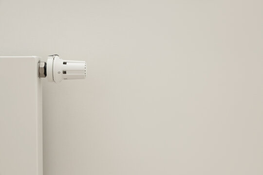 A radiator valve is installed in a clean and simple room