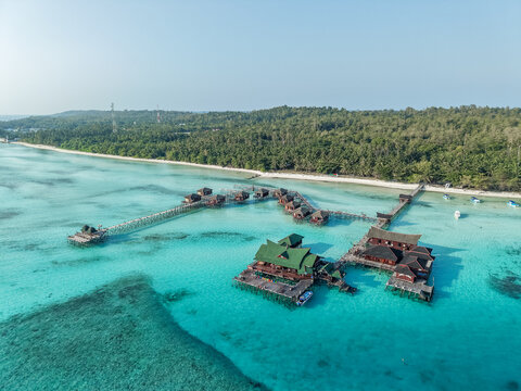 Aerial view of Maratua Island featuring turquoise waters, coral reefs, and white sandy beaches in Berau, East Kalimantan, Indonesia.