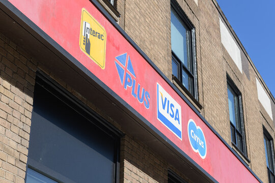 financial services logos (Interac, Plus, Visa, Cirrus) on the exterior of Scotiabank branch at 292 Spadina Av, Toronto (Chinatown)