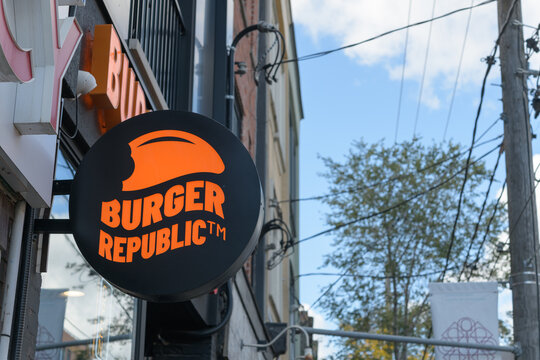 round projecting sign outside Burger Republic, a hamburger restaurant, located at 1171 Dundas St W, Toronto