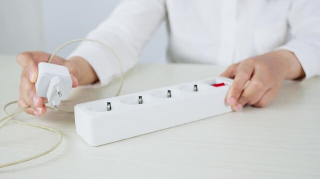 Unplugging a Charger From a Wall Socket