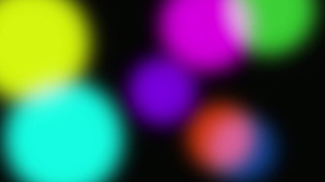 Abstract colorful bokeh lights moving and shifting on a black background