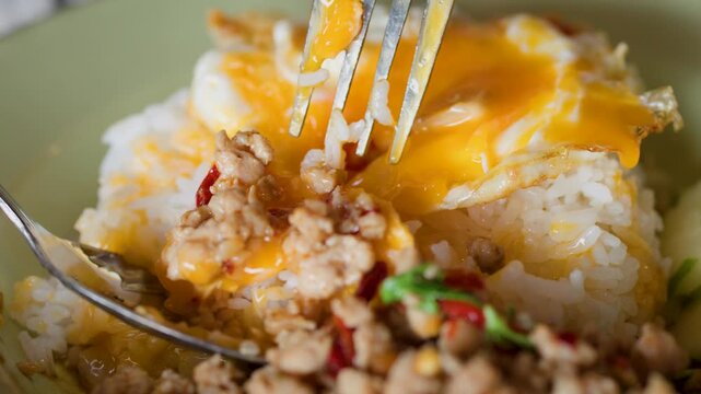 Eating Thai Pad Krapow Minced Pork with Fried Egg and Rice