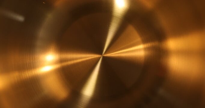 Shiny gold metallic texture with circular pattern and bright