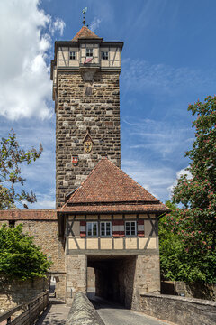 R&ouml;derturm and R&ouml;dertor in Rothenburg ob der Tauber, Germany, showcasing medieval stone fortifications, a half-timbered gatehouse, and the historic charm of Bavaria.