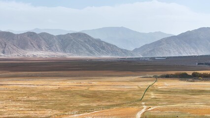 Fototapeta premium vast grassland and distant mountains landscape in xinjiang