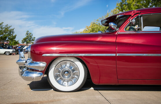 Front side view of a red 1951 Mercury Eight classic car