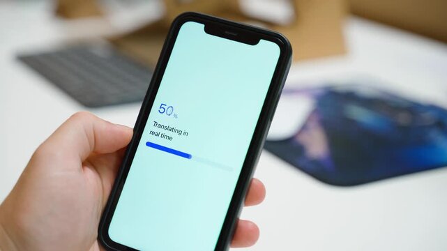 Hand holding smartphone with real time translation loading then failing. Translation failed error message on mobile screen