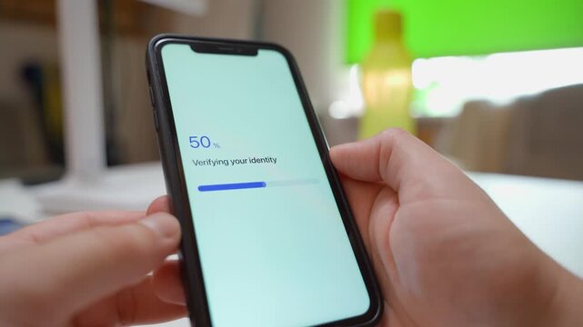 Hands holding smartphone with app verifying identity and showing verification failed error