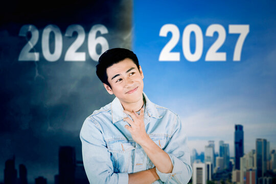 Thoughtful Man Looking Forward from Stormy 2026 to Bright 2027 Future