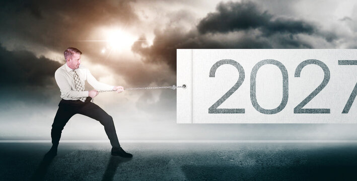 Businessman Pulling Big 2027 Banner with Chain Under Stormy Sky