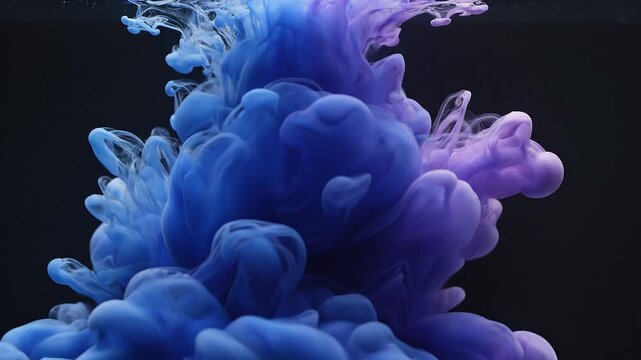 Blue and purple ink drops disperse in water.