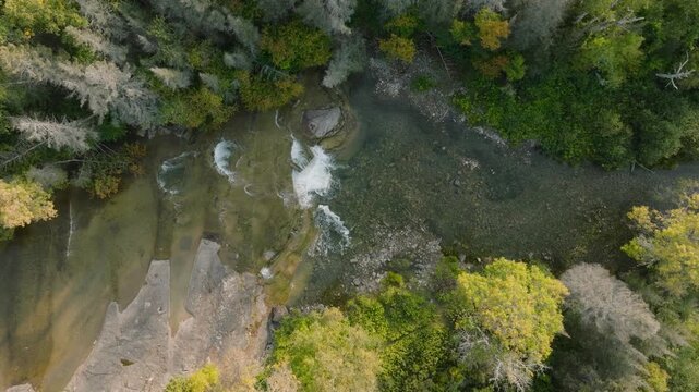 Top down aerial of a rocky waterfall in the woods, Manitoulin Island